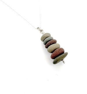 pendant made of Sterling Silver wire going through a Stack of smooth Stones. 