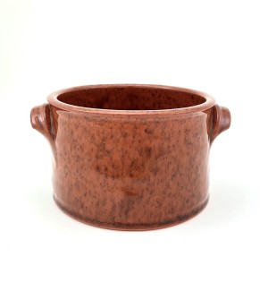 A straight sided red ware crock with small handles on either side.
