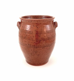 A red ware jar with small handles on either side.