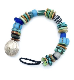 a bracelet made with a colorful assortment of different shaped beads with a button clasp made from a coin.