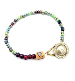 a bracelet made with a colorful assortment of different shaped smaller beads and a silver button clasp.