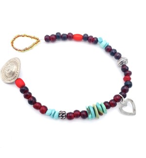 a bracelet made with a colorful assortment of different shaped beads and a silver heart charm with a silver button clasp.