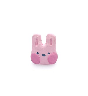 hand sculpted polymer clay pin of a pink cartoonish rabbit head.
