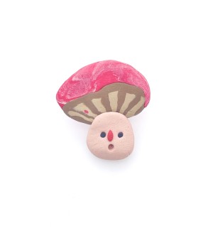hand sculpted polymer clay pin of a cartoonish mushroom with pink top and silly face.