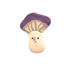hand sculpted polymer clay pin of a cartoonish mushroom with silly face.