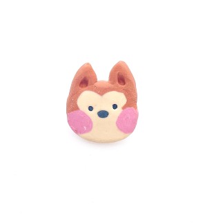 hand sculpted polymer clay pin of a cartoonish shiba inu dog head with pink cheeks.