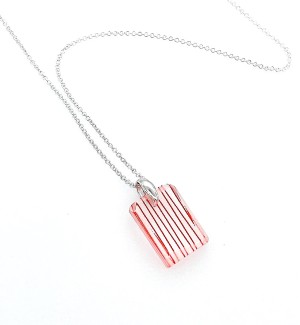 red string suspended in a rectangular resin Pendant with a Sterling silver bail on a silver chain.