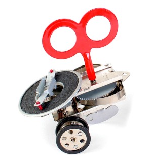 A wind up toy with a large red winder.