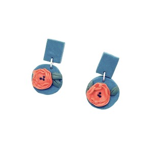 hand sculpted polymer clay dangle Earrings that are blue with an orange poppy flower on them.