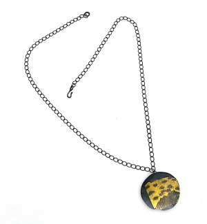 oxidized Sterling Silver chain and disk pendant with 23K Gold leaf on it.