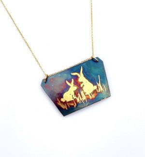 Copper trapezoid pendant with 23K Gold Rabbits in grass on a gold filled chain.