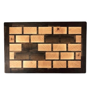 Wooden charcuterie Board with rectangle grid pattern in lighter wood as well as five darker wood rectangles and dark wood border.