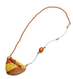 Sculptural Necklace with orange beads and hand-stitched fabric pendant in yellow and orange.