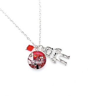A red pendant with a circuit board design and silver astronaut charm and red diamond shaped bead on a silver chain.