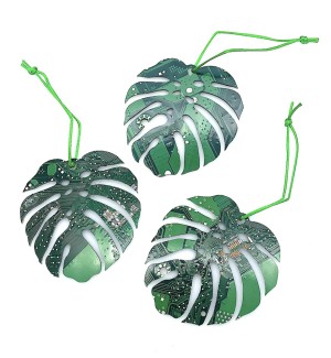 Three green perforated slashed leaf shaped ornaments made of cut circuit board hung on a green string.
