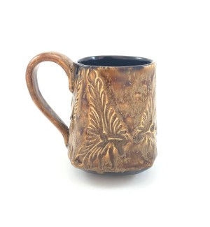 Handbuilt brown Ceramic Mug stamped with decorative pattern with a black inside.