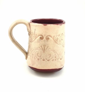 Handbuilt cream and wine red Ceramic Mug stamped with decorative pattern.