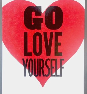 Letterpress Print poster that says 'Go Love Yourself' on top of a red heart.