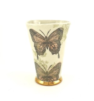 White Tumbler with orange butterfly and a gold rim at the base. 