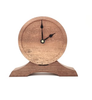 wooden round clock face with lip mounted onto a different toned swooping base.