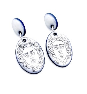 hand illustrated Ceramic dangle Earrings with a line drawing of Medusa's head on them.