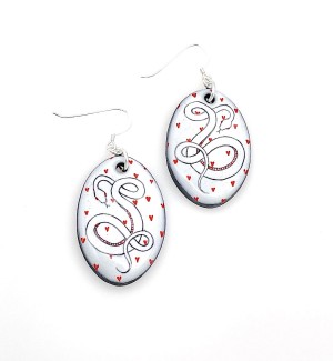 hand illustrated Ceramic dangle Earrings with small red hearts and a black line drawing of a snake with red details.