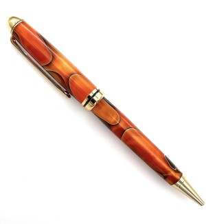 A pen with gold hardware and an orange body with black swirls throughout.