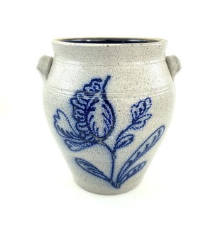 Open ceramic vessel with compact side grasp handles. Glaze is light grey with hand illustrated flower on stem in cobalt blue.