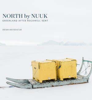 Book cover of a snow covered and grey skied landscape with a long wood dog sled holding two large yellow storage crates.