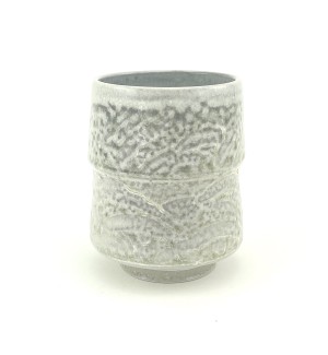 Ceramic tiered cup with a subtle, mottled and pebbled surface in greys and whites.