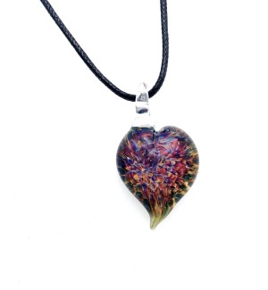 Glass heart shaped Pendant with multicolored floral-like pattern inside with a clear bail on a black cord.