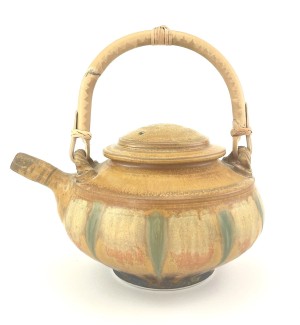 sand colored Hand thrown ceramic teapot with subtle greens and a bamboo handle.