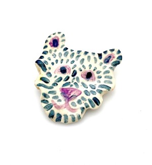 Handformed ceramic pin in the shape of a cartoonish tiger face with a pink nose.