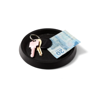 Round black cast iron tray with keys and paper money.