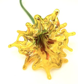 Glass flower that has a multi-colored throat and a full bright yellow colored petaled bloom with a long green stem.