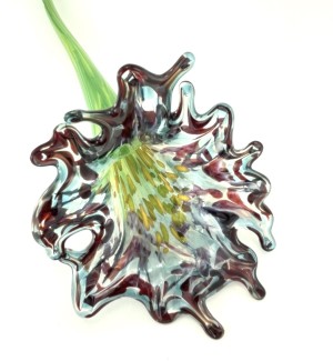 Glass flower that has a multi-colored throat and a full dark purple colored petaled bloom with a long green stem.
