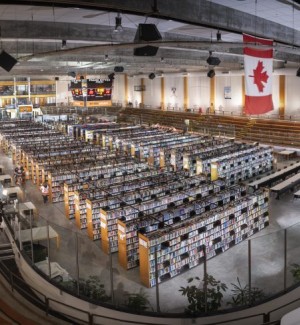 color photograph of the full vista of a former indoor ice rink transformed into a library with books on shelves.