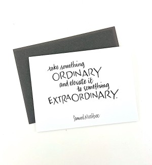 White paper greeting card with calligraphy 'take something ORDINARY and elevate it to something EXTRAORDINARY' on cover. Dark grey envelope.