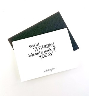 White paper greeting card with calligraphy 'Don't let YESTERDAY take up too much of TODAY' on cover. Dark grey envelope.