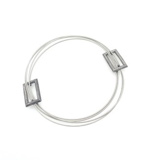 a bracelet made from a continuous steel cable that creates a multi strand effect that weaves in and out of two cast and fabricated Sterling silver forms. 