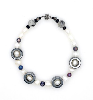 Bracelet made of a variety of pearl, glass, and stone beads.