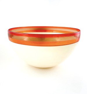 a glass bowl with a smooth surface and ivory color base, a band of rose, bronze and melon colored band around the rim.