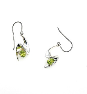 A pair of silver, wave shaped earrings with a green gemstone at the center of each earring.