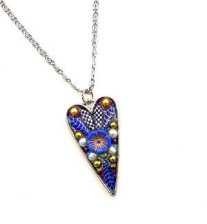 a heart shaped pendant with a cluster of beads encased in acrylic.