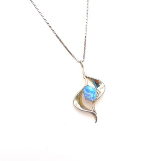 a silver ogee shaped pendant with a blue gemstone.