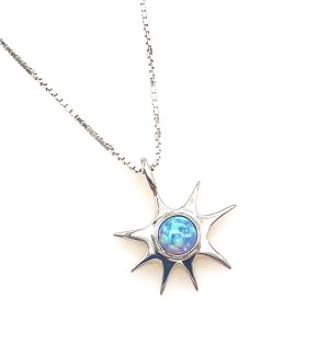 a silver pendant in the shape of a star with a blue stone in the center.