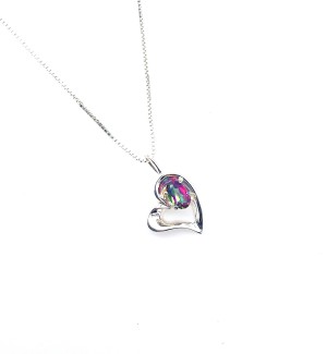 A silver heart shaped pendant with a greenish purple stone perched on top.