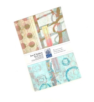 A hand collaged and stitched journal with various decorative patterns and colors.