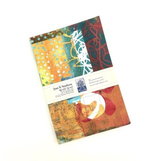 •	Artist information card A hand collaged and stitched journal with various decorative patterns and colors.