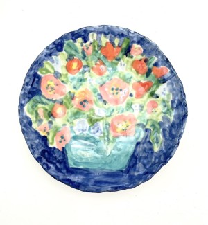 a round ceramic plate with a hand illustrated floral bouquet.